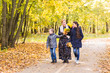 © satura_ - Happy young family spending time together outside in autumn nature.