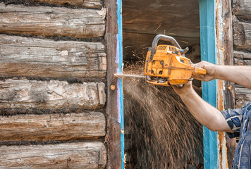  man sawing a window