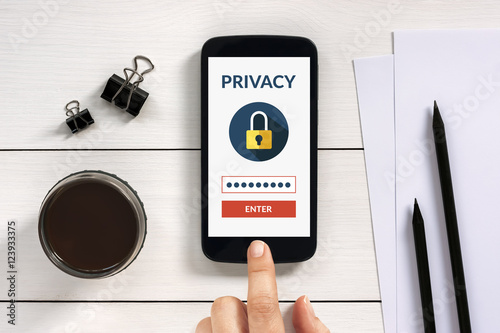 Fotografía Online privacy concept on smart phone screen with office objects