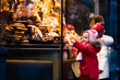 © famveldman - Kids looking at candy and pastry on Christmas market