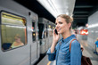 © Halfpoint - Woman making phone call at the underground platform, waiting
