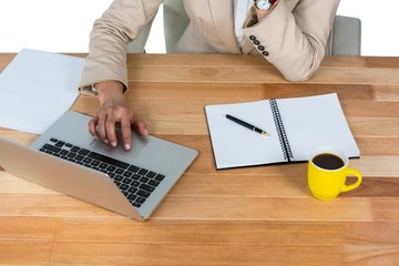 Poster - Businesswoman using laptop with diary and black coffee on table