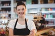 © WavebreakMediaMicro - Portrait of smiling waitress standing with arms crossed