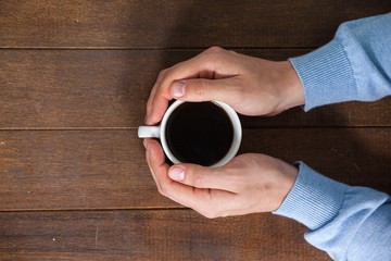 Poster - Man holding a cup of coffee