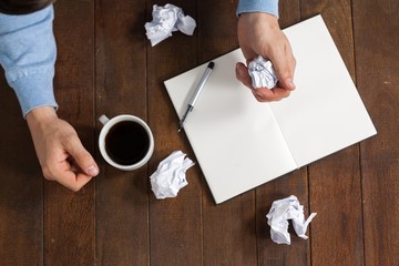 Poster - Man crumpling paper while having cup of coffee