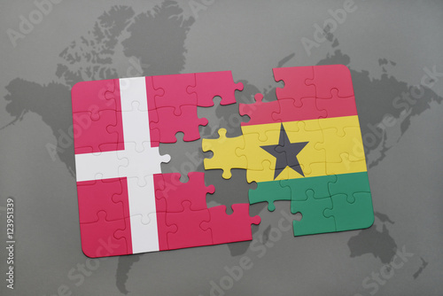 Photo puzzle with the national flag of denmark and ghana on a world map background