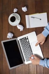 Poster - Man using laptop while writing on notepad