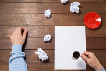 Poster - Man holding cup of coffee on paper