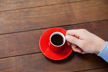 Poster - Man holding a cup of coffee