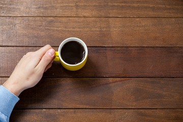 Poster - Man holding a cup of coffee
