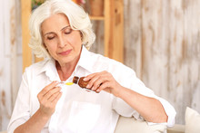 Sick Old Woman Preparing Medication Against Cough