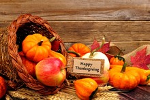 Happy Thanksgiving Tag And Cornucopia With Autumn Fruit And Vegetables On Rustic Wood Background