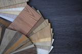 Fototapeta  - Laminate Wood Concept - Samples of laminate and vinyl floor tile on wooden Background wo