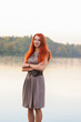 © pliekhova - Outdoors portrait of beautiful smiling woman with red hair