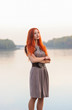 © pliekhova - Outdoors portrait of beautiful smiling woman with red hair