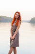 © pliekhova - Outdoors portrait of beautiful smiling woman with red hair