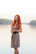 © pliekhova - Outdoors portrait of beautiful smiling woman with red hair