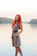 © pliekhova - Outdoors portrait of beautiful smiling woman with red hair
