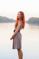 Wall Mural - Outdoors portrait of beautiful smiling woman with red hair