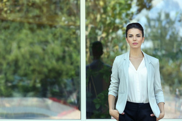 Wall Mural - Beautiful businesswoman on window background