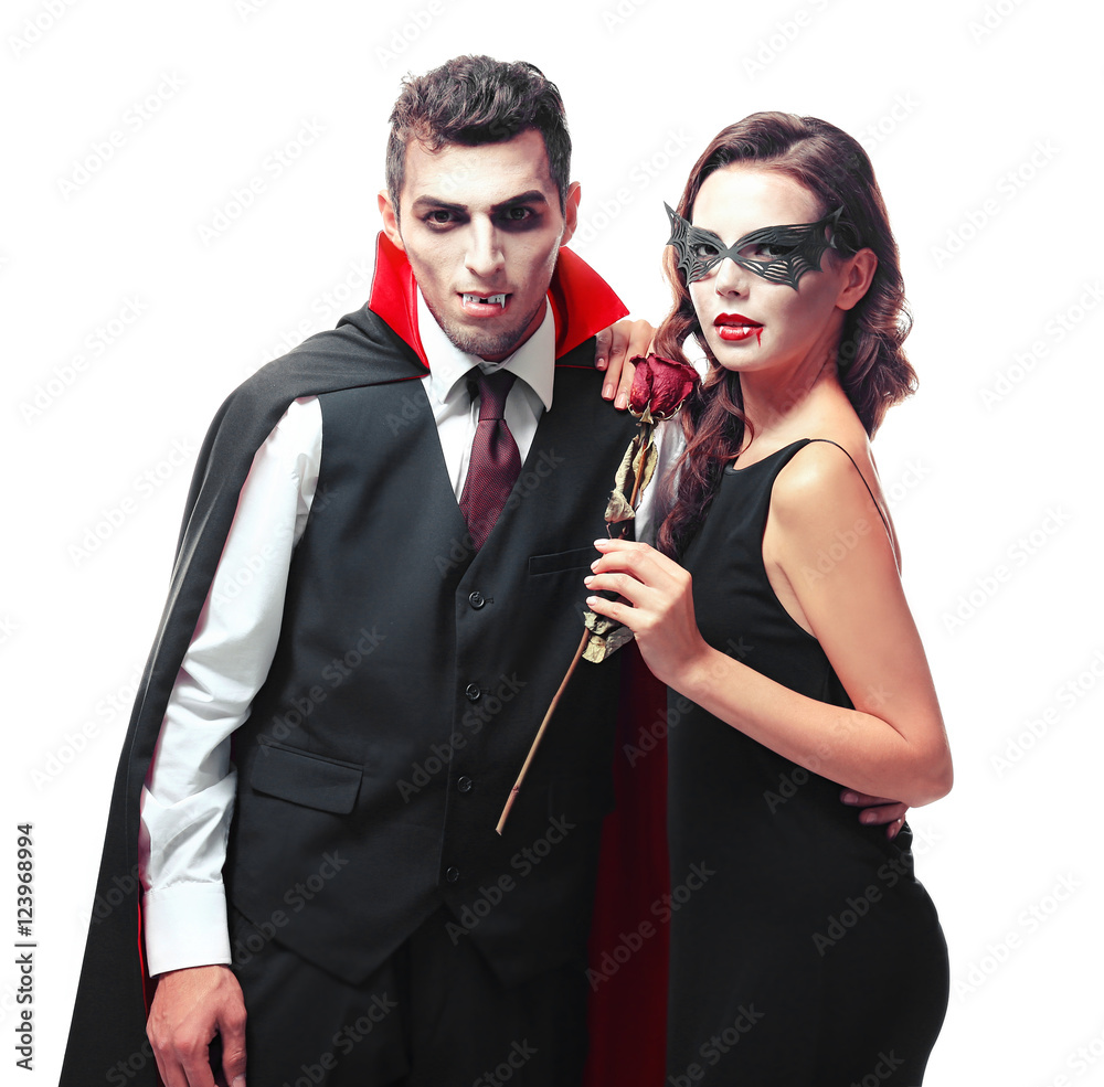 Young couple dressed in vampire costumes for Halloween, isolated on white