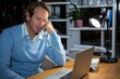 © WavebreakMediaMicro - Businessman talking on phone while working in office