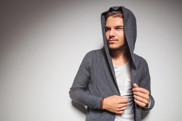 Wall Mural - young casual man with hoodie on looking to side