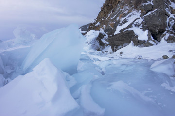 grey ice of lake baikal in cloudy weather