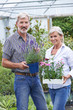 © highwaystarz - Mature Couple Choosing Plants At Garden Center