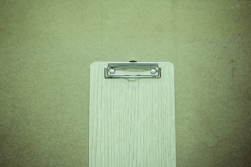 Clipboard on wooden table top