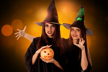 young beautiful women with pumpkins in hands