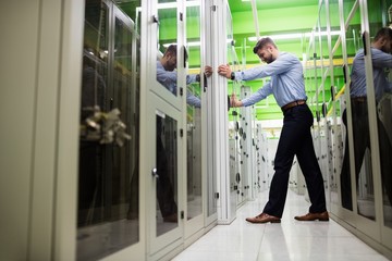 Wall Mural - Technician adjusting server cabinet