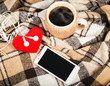 Hot coffee, white mobile phone with headphones, soft red heart