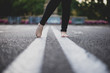 © ADDICTIVE STOCK - Walking along white zebra line, barefoot.