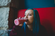 © ADDICTIVE STOCK - Girl with blue hair drinking a juice