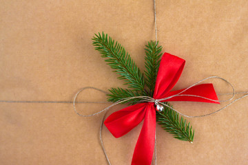 Holiday gift wrapping with a red bow and rope