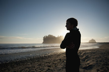 A Young Man Stands On The Beach At Sunset; La Push Washington United States Of America