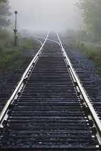 Railway Track In The Early Morning Mist; Ville De Lac Brome, Quebec, Canada