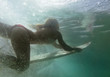 © Designpics - A Woman On A Surfboard Under The Water; Tarifa, Cadiz, Andalusia, Spain