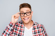 © deagreez - Happy man with beaming smile touching his glasses