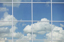 A Blue Sky With Clouds Through A Window; Edmonton, Alberta, Canada
