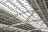 Fototapeta  - Gray and white metal roof structure in sunny day.