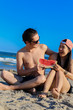© baconstudiony - couple eat watermelon on the beach