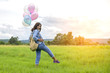 © sunti - Happy young beautiful woman with colorful balloons