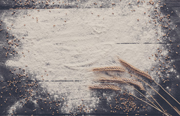 Canvas Print - baking concept on wood background, sprinkled flour with copy space