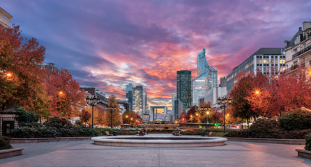 La Defense Financial district at sunset with autumn colors in Paris, France.