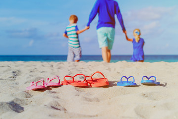 Wall Mural - father with son and daughter walking at beach