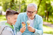 © Syda Productions - old man and boy eating ice cream at summer park