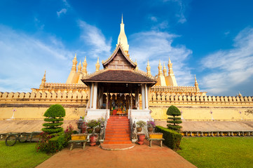 Wall Mural - Religious architecture and landmarks. Golden buddhist pagoda of Phra That Luang Temple under sunset sky. Vientiane, Laos travel landscape and destinations