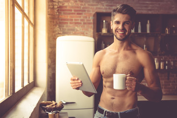 Sexy young man in kitchen